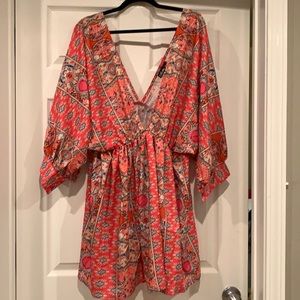 Coral dress with tan, black, lt blue, navy print.